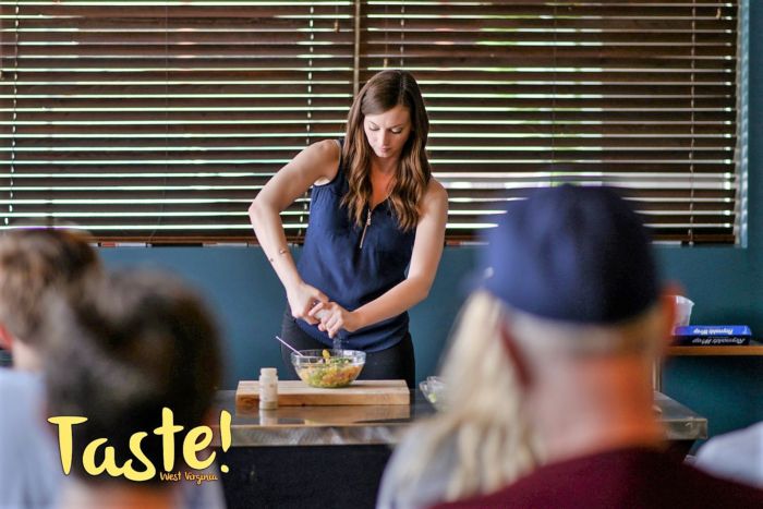 Brittany Furbee giving a cooking demonstration at Taste-of-All Charleston