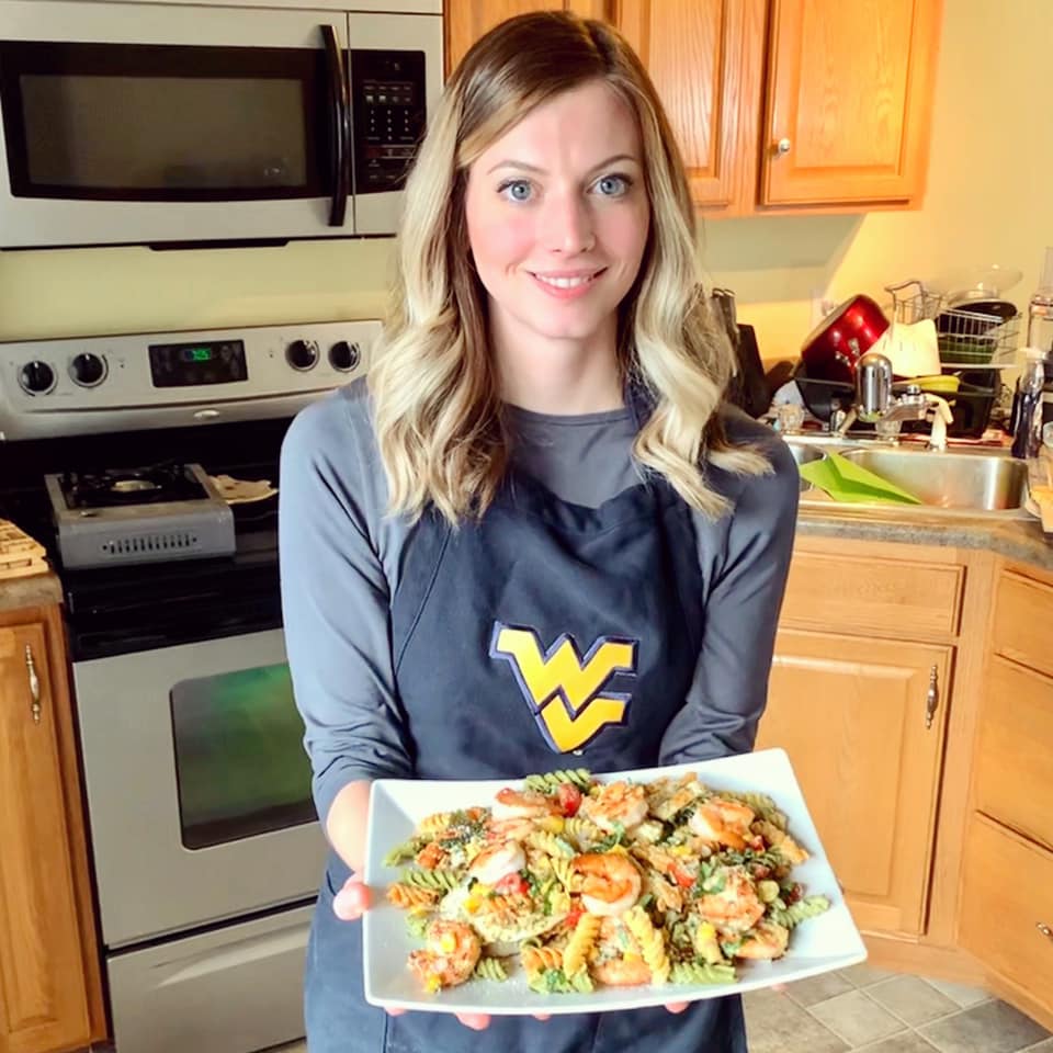 Brittany Furbee holding summer scampi pasta salad during a virtual cooking demo.